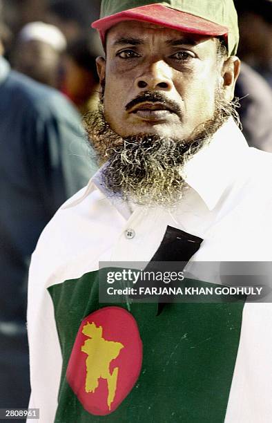 Unidentified Bangladeshi man wears a T-shirt printed with Bangladesh's first designed flag at the mausoleum of martyred intellectuals in Dhaka, 14...