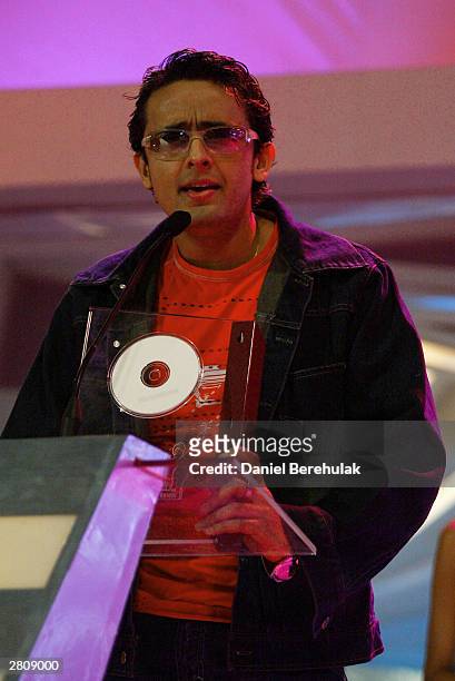 Sonu Nigam receives his award for best singer male during the Inaugural MTV IMMIES at the Goregaon Sports Club December 12, 2003 in Mumbai, India.