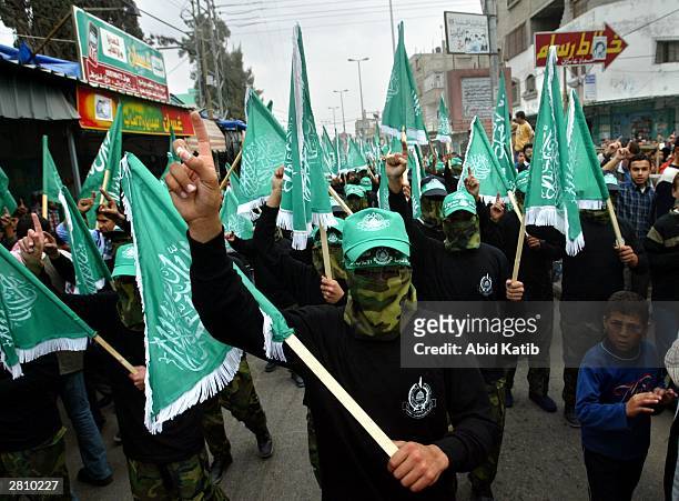 Masked Palestinian members of the Islamist Hamas movement march during a demonstration in the southern Gaza Strip refugee camp of Rafah December 14,...