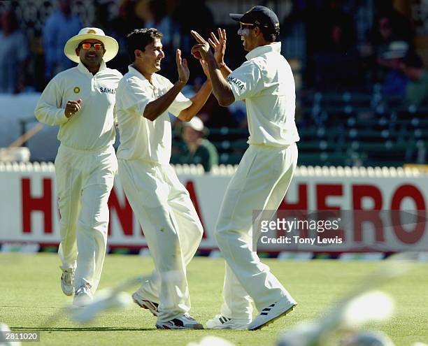 Ajit Agarkar congratulates Akash Chopra after the wicket of Simon Katich, caught Chopra bowled Agarkar for 31, in the second Test between Australia...