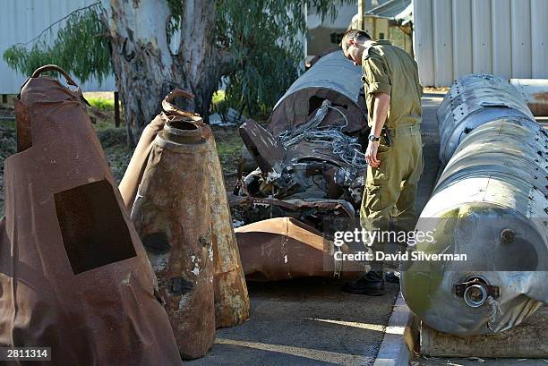 An Israeli army officer looks over parts of Iraqi Scud missiles, including two warheads in this November 14, 2002 file photo at an Israeli Defense...