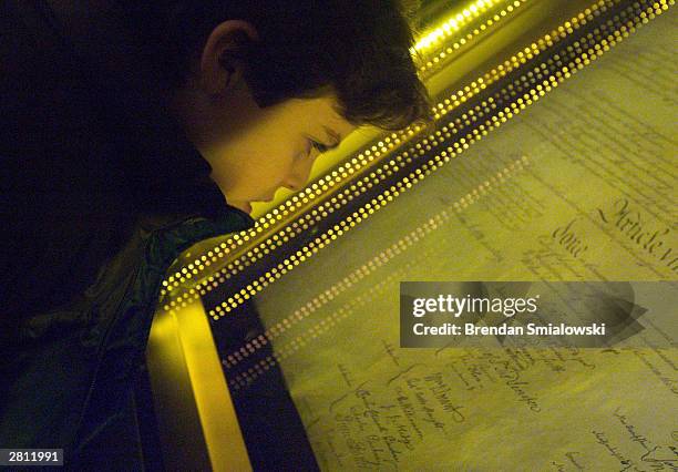 Ethan Kasnett, an 8th grade student at the Lab School in Washington, DC, views the original constitution after a ceremony unveiling the people's...