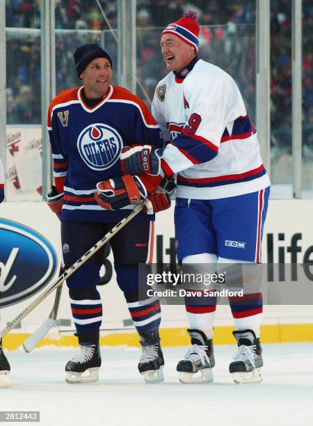 Defenseman Paul Coffey of the Edmonton Oilers shares a laugh with Larry Robinson of the Montreal Canadiens during the Molson Canadien Heritage...