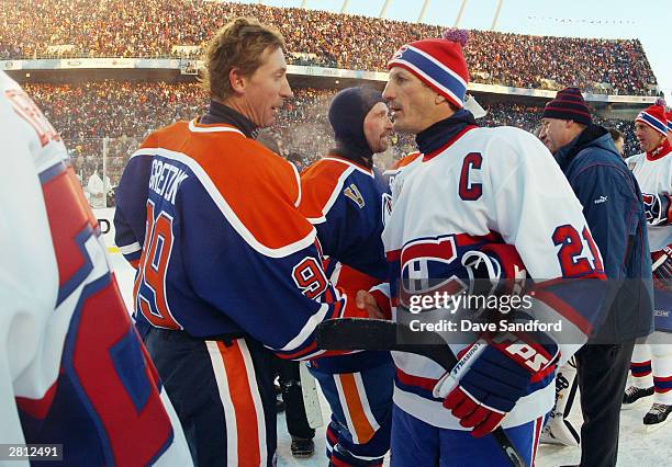 Wayne Gretzky of the Edmonton Oilers shakes hands with Guy Carbonneau of the Montreal Canadiens during the Molson Canadien Heritage Classic on...