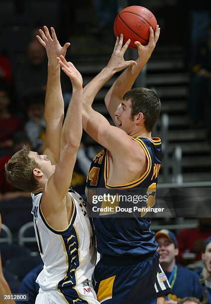 Kevin Pittsnogle of the West Virginia University Mountaineers shoots over Rock Battistoni of the George Washington Colonials during the BB&T Classic...