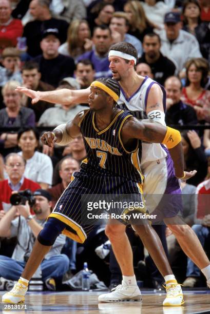 Jermaine O'Neal of the Indiana Pacers and Brad Miller of the Sacramento Kings battle for position during the NBA game at Arco Arena on December 7,...