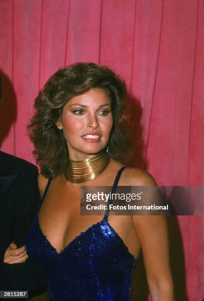 American actor Raquel Welch attends the Academy Awards ceremony, wearing a blue evening dress and gold necklace, at the Dorothy Chandler Pavilion of...