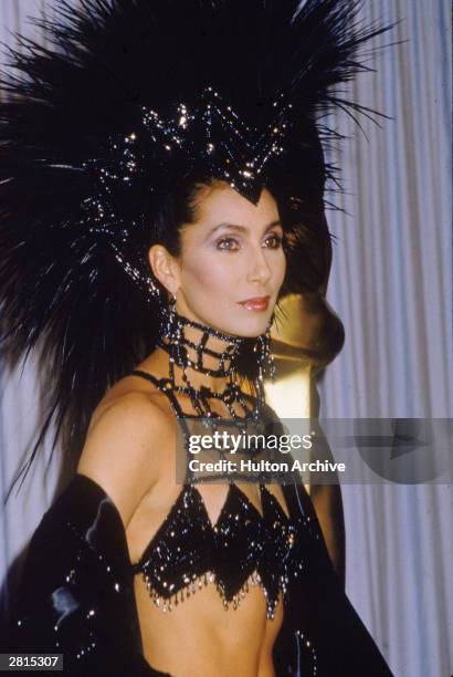 American actor and singer Cher attends the Academy Awards ceremony, wearing a black headdress, at the Dorothy Chandler Pavilion of the LA Music...