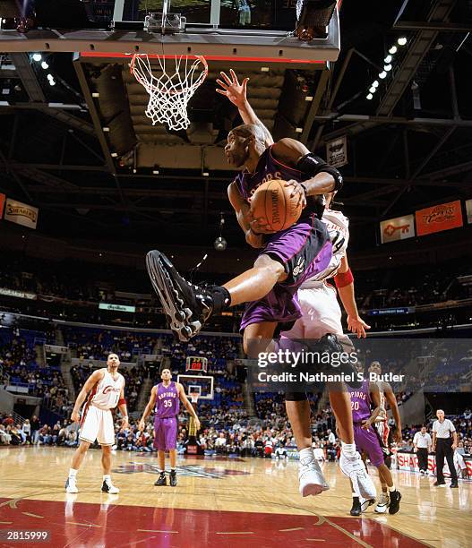 Vince Carter of the Toronto Raptors makes a layup against the Cleveland Cavaliers at Gund Arena on December 9, 2003 in Cleveland, Ohio. The Raptors...