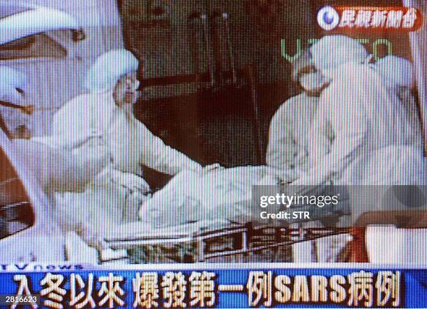 Grab from Formosa TV shows a Severe Acute Respiratory Syndrome patient being transferred to the Taipei Municipal Hoping Hospital, 17 December 2003....