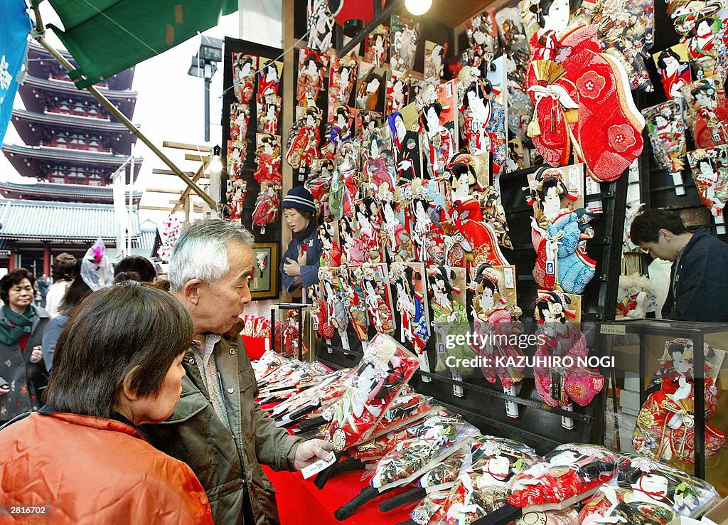 Customers check a wooden paddle called '
