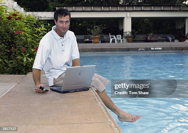 England captain Michael Vaughan stays in touch with his laptop and iPac, on December 17, 2003 in Colombo, Sri Lanka.