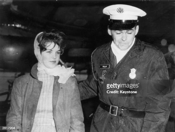 Year old Priscilla Beaulieu is led away by a military policeman whilst trying to say goodbye to her friend Elvis Presley at Frankfurt Airport, 2nd...