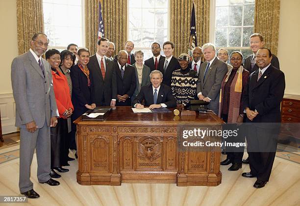 President George W. Bush signs H. R. 3491, the National Museum of African-American History and Culture Act, in the Oval Office December 16, 2003 in...