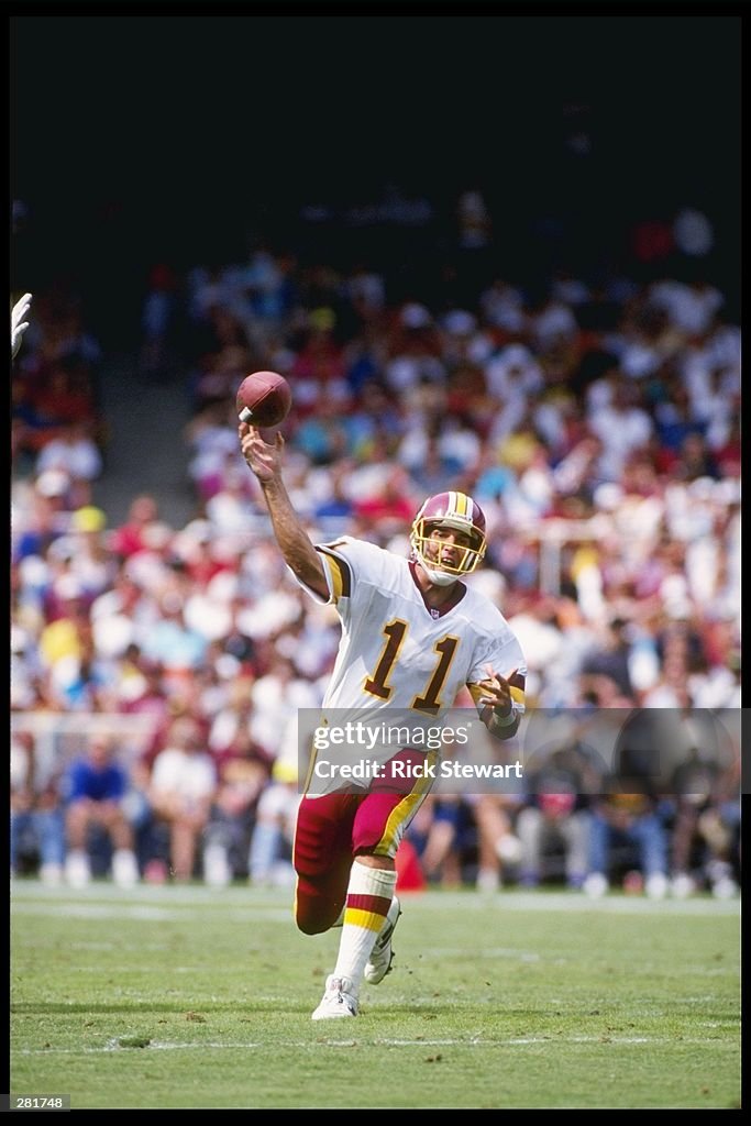 Quarterback Mark Rypien of the Washington Redskins passes the ball ...