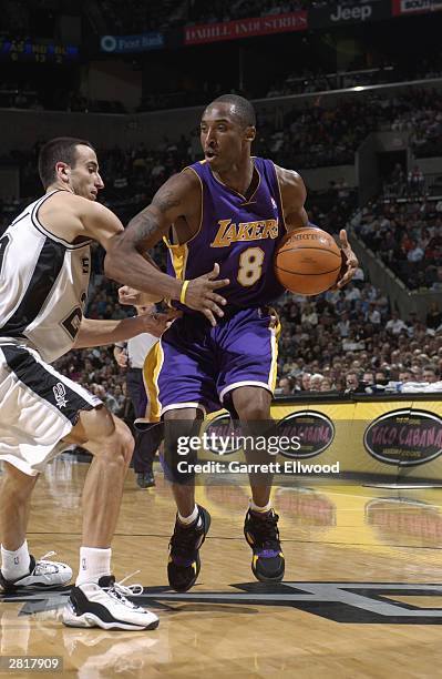 Kobe Bryant of the Los Angeles Lakers looks to make a move on Emanuel Ginobili of the San Antonio Spurs at SBC Center on December 3, 2003 in San...