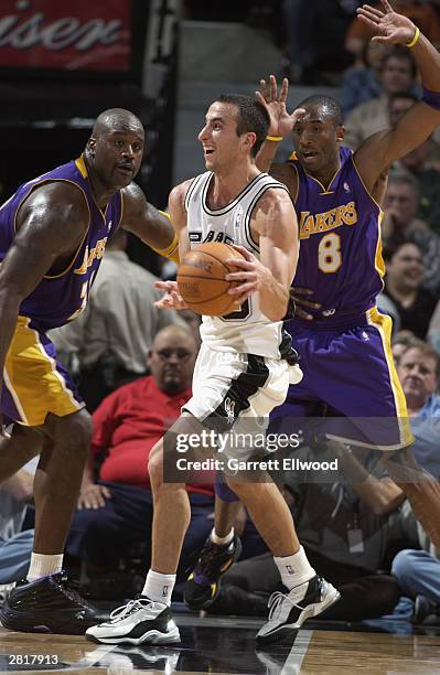 Emanuel Ginobili of the San Antonio Spurs passes the ball as he is double-teamed by Shaquille O'Neal and Kobe Bryant of the Los Angeles Lakers at the...