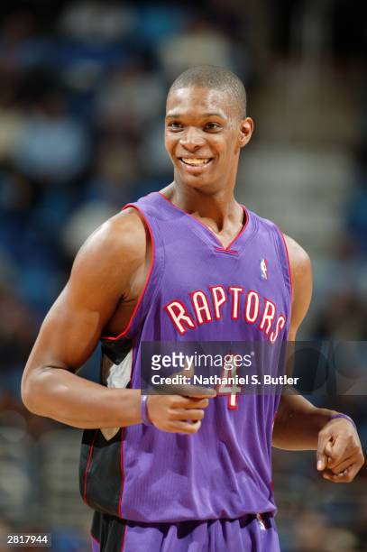 Chris Bosh of the Toronto Raptors smiles during the game against the Cleveland Cavaliers at Gund Arena on December 9, 2003 in Cleveland, Ohio. The...