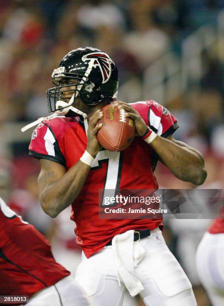 Quarterback Michael Vick of the Atlanta Falcons drops back to pass during the game against the Carolina Panthers on December 7, 2003 at the Georgia...