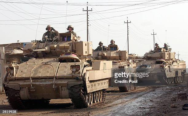 Bradley fighting vehicles from 1-8, 3rd Brigade, of the 4th Infantry Division prepare to leave the industrial zone December 17, 2003 in Samarra,...