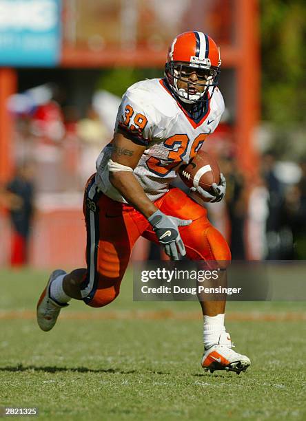 Running back Walter Reyes of the Syracuse University Orangemen adjusts his helmet during the game against the University of Miami Hurricanes at the...