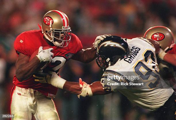 SAN FRANCISCO RUNNINGBACK RICKY WATTERS STIFF-ARMS SAN DIEGO LINEBACKER DAVID GRIGGS DURING THE THIRD QUARTER OF THE SAN FRANCISCO 49ERS VERSUS THE...