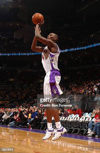 Chris Bosh of the Toronto Raptors shoots against the Miami Heat during the game at Air Canada Centre on December 14, 2003 in Toronto, Canada. The...