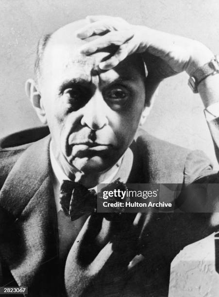 Headshot portrait of Austrian-born American composer Arnold Schoenberg with his hand to his forehead, circa 1925.