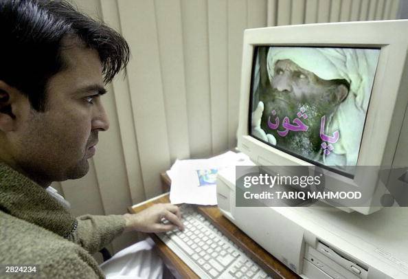An unidentified Pakistani man watches a An unidentified Pakistani man watches a