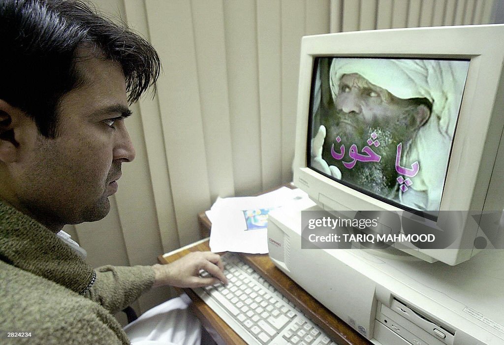 An unidentified Pakistani man watches a 