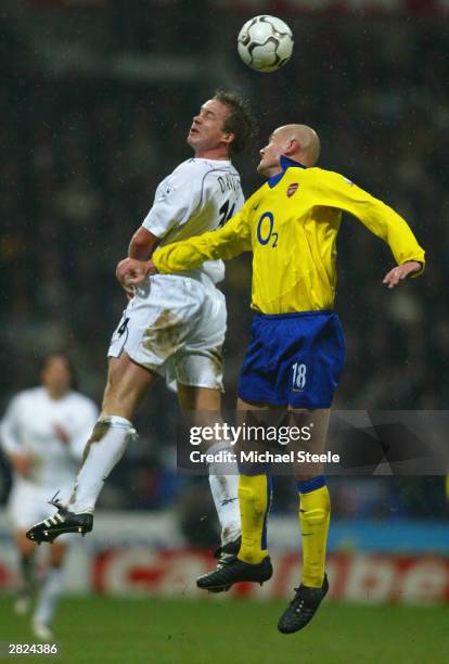 Kevin Davies of Bolton jumpsfor the ball with Pascal Cygan of Arsenal during the FA Barclaycard Premiership match between Bolton Wanderers and...