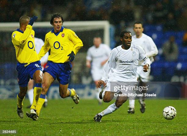 Jay Jay Okocha of Bolton breaks away from Gilberto Silva and Robert Pires of Arsenal during the FA Barclaycard Premiership match between Bolton...