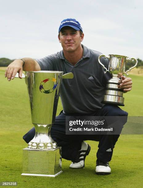 Peter Lonard of NSW with the PGA Tour Order of Merit trophy and the Stonehaven Cup after winning the 2003 Australian Open at Moonah Links on December...