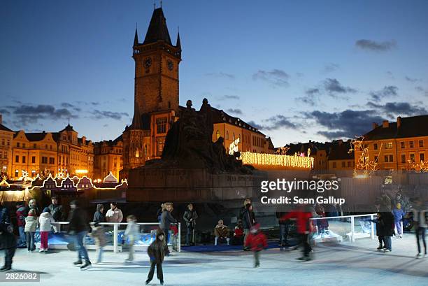 Ice skaters and Christmas shoppers enjoy Christmas atmosphere on Old Town Square December 21, 2003 in Prague, Czech Republic. Retailers throughout...