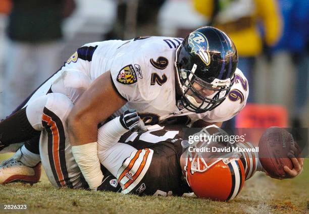 Quarterback Tim Couch of the Cleveland Browns is sacked by Maake Kemoeatu of the Baltimore Ravens during the fourth quarter on December 21, 2003 at...