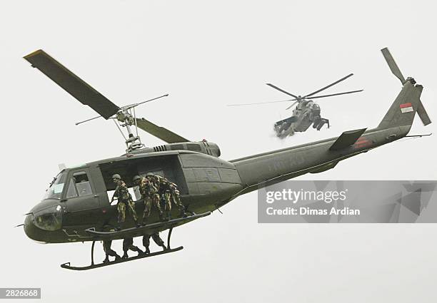 Millitary helicopters from the Army's Raider Battalions fly above during a display attended by more than 11,000 soldiers in an Army Day parade on...