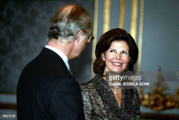 Swedish Queen Silvia smiles at her husband, King Carl Gustaf during a reception at the Royal Palace in Stockholm, Sweden, 22 December 2003 the eve of...