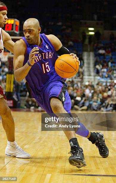 Vince Carter of the Toronto Raptors drives to the hoop as he is covered by Ira Newble of the Cleveland Cavaliers during the game at Gund Arena on...