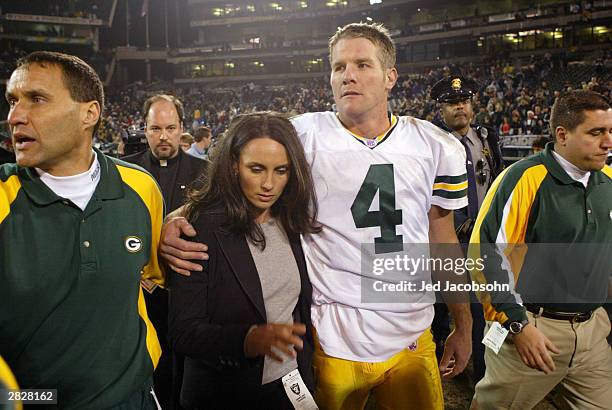 Brett Favre of the Green Bay Packers leaves the field with his wife Deanne after defeating the Oakland Raiders after an NFL game on December 22, 2003...