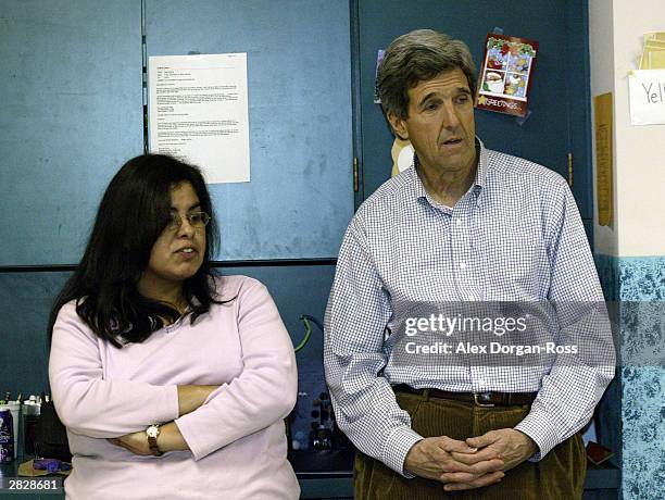 Democratic Presidential candidate U.S. Senator John Kerry stands next to teacher's assistant, Carmen Toney, during a campaign stop at a community...