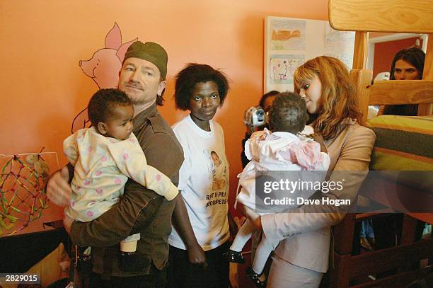 Singers Beyonce Knowles and Bono of U2 visit the Baphumelele Children's Home in Khayalitsha on December 5, 2003 in South Africa. The AIDS epidemic in...