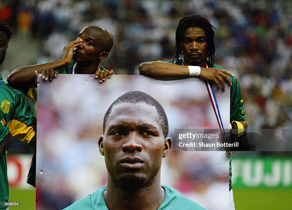 Rigobert Song and Samuel Eto'o of Cameroon hold a picture of team-mate and friend Marc-Vivien Foe who tragically died on the pitch in the previous match