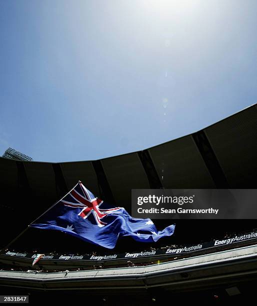 An Australian flag is held up during day one of the Boxing Day test, 3rd test between Australia and India at the Melbourne Cricket Ground, December...