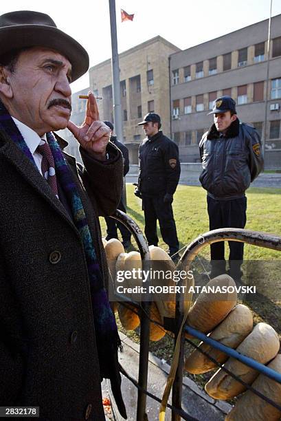 Demonstrator leaves bread in front of the Macedonian Parliament building, as part of a protest by angry farmers, 26 December 2003 in Skopje. The...