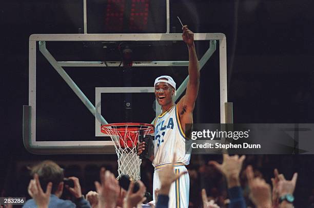UCLA FORWARD ED O''BANNON CELEBRATES BY CUTTING HIS PART OF THE NET AFTER THE BRUINS 102-96 WIN OVER UCONN IN THE NCAA WEST REGIONAL FINAL AT THE...