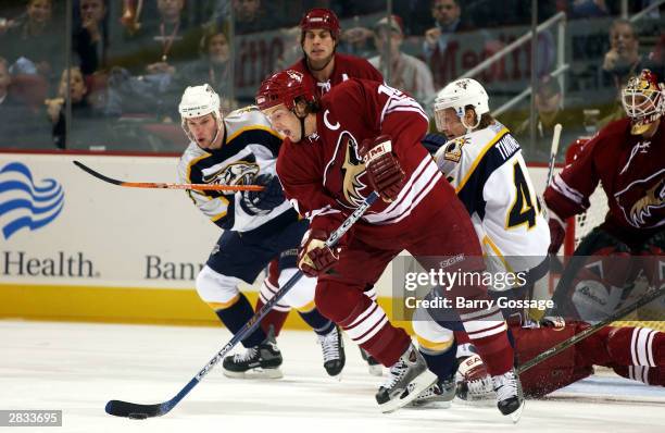 Shane Doan of the Phoenix Coyotes skates with the puck against the Nashville Predators on December 27, 2003 at Glendale Arena in Glendale, Arizona....