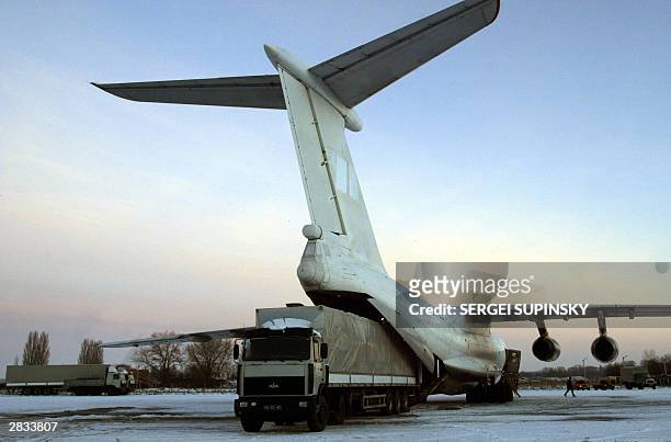 Plane is loaded with humanitarian assistance, medicaments and mobile hospital, from onto a Ilyushin-76 plane at Kiev's airport before it's flight to...