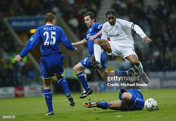 Jay Jay Okocha of Bolton leaps above Callum Davidson as Muzzy Izzet challenges during the FA Barclaycard Premiership match between Bolton Wanderers...