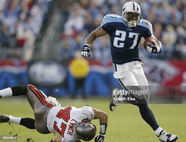 Eddie George of the Tennessee Titans avoids getting tackled by John Lynch of the Tampa Bay Buccaneers on December 28, 2003 at The Coliseum in...