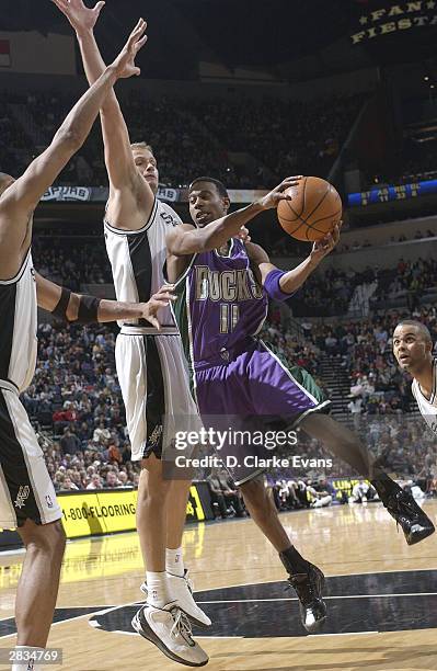 Ford of the Milwaukee Bucks drives against Rasho Nesterovic of the San Antonio Spurs during the game on December 28, 2003 at the SBC Center in San...